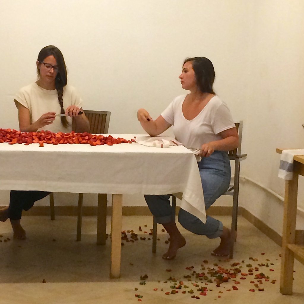 The cleaned and prepared strawberries spread across the table.